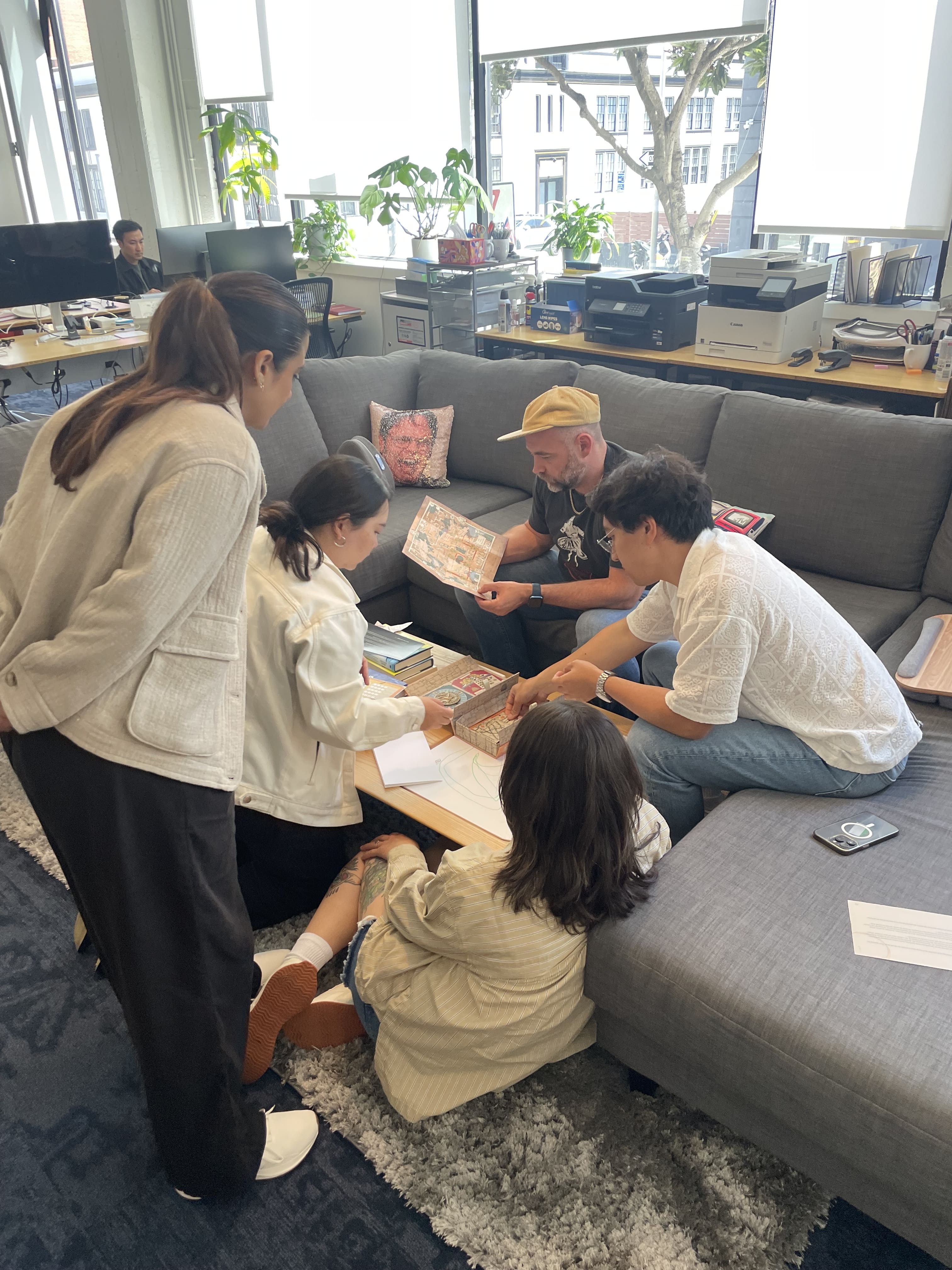 Employees solving the Jidara Puzzle Box together